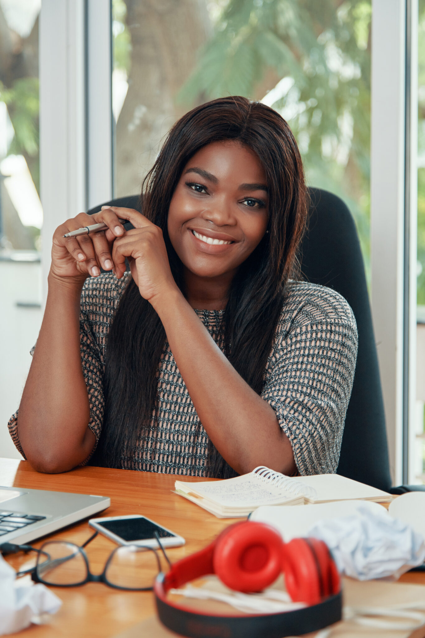content ethnic businesswoman at working desk